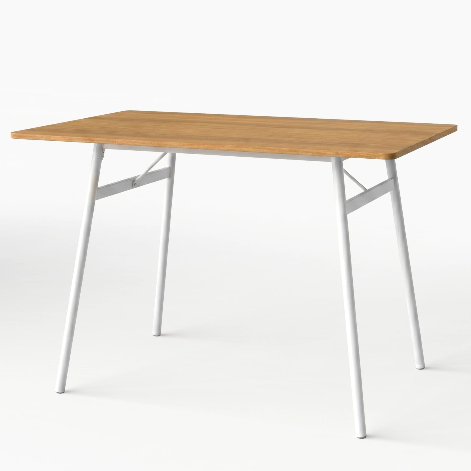 [Oak] Torvi dining table alone on white background showing warm oak-effect MDF top and white metal angled legs with cross-brace frame detail