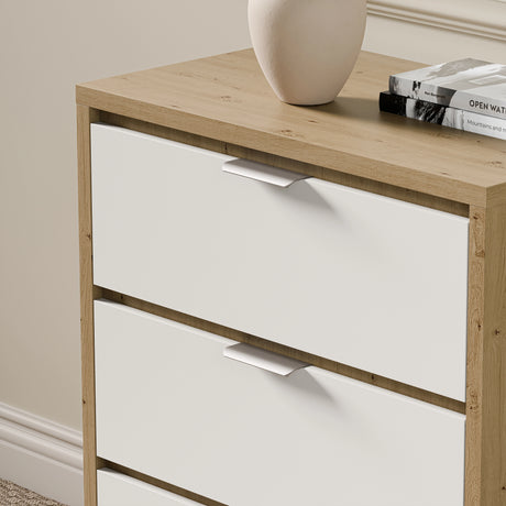 Skova bedroom chest of drawers placed against a wall with decorative items and books on top