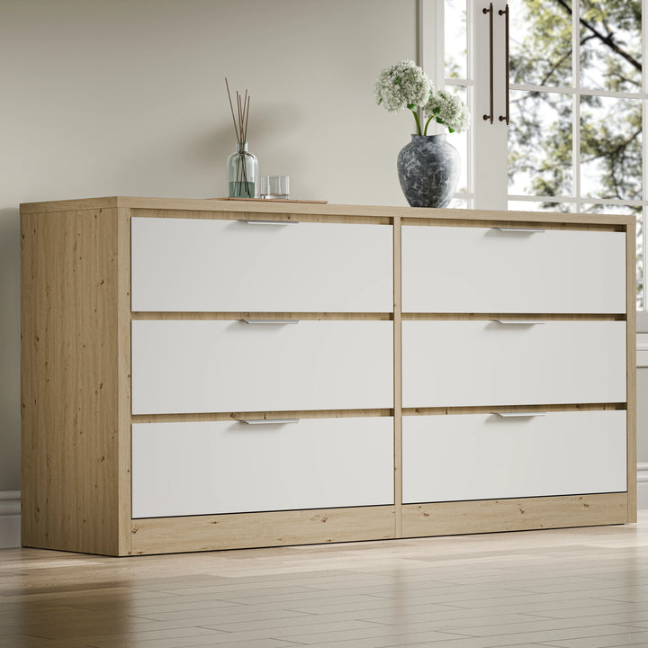 [Oak+White] Skova 6 drawer chest angled hero with oak side panels white drawer fronts and silver bar handles