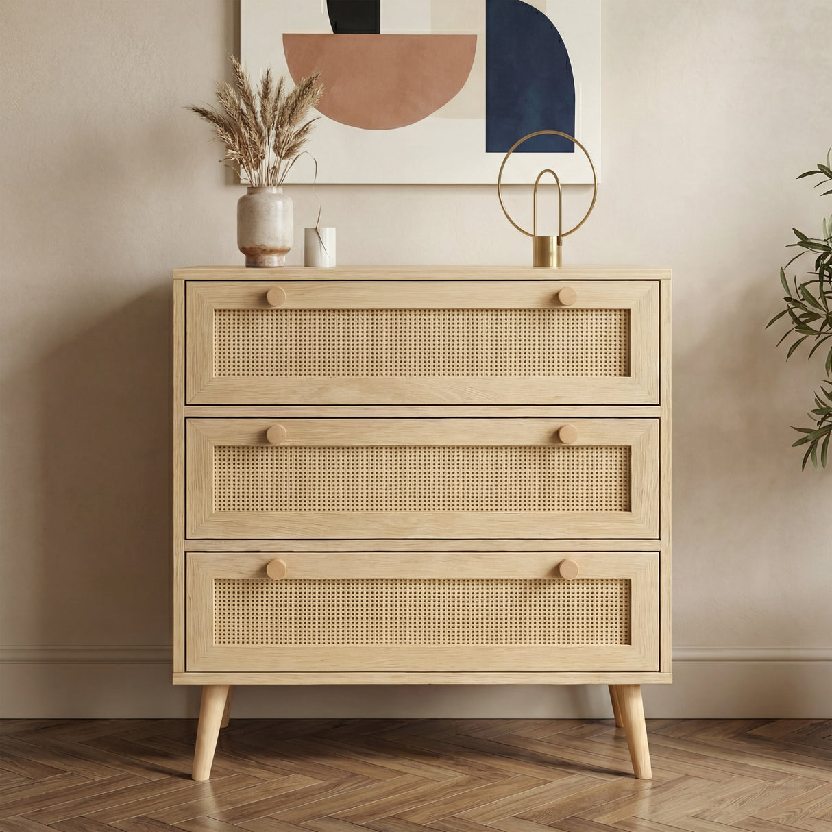 [Oak Effect] Wovena chest of drawers front view with three rattan-panel drawers, oak knobs, tapered legs, and vase on top