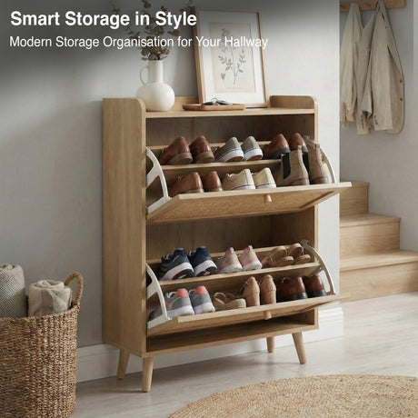 [Oak] Wovena shoe cabinet with both flip drawers open showing two rows of shoes and boots on internal shelves, styled in hallway with staircase and coat hooks