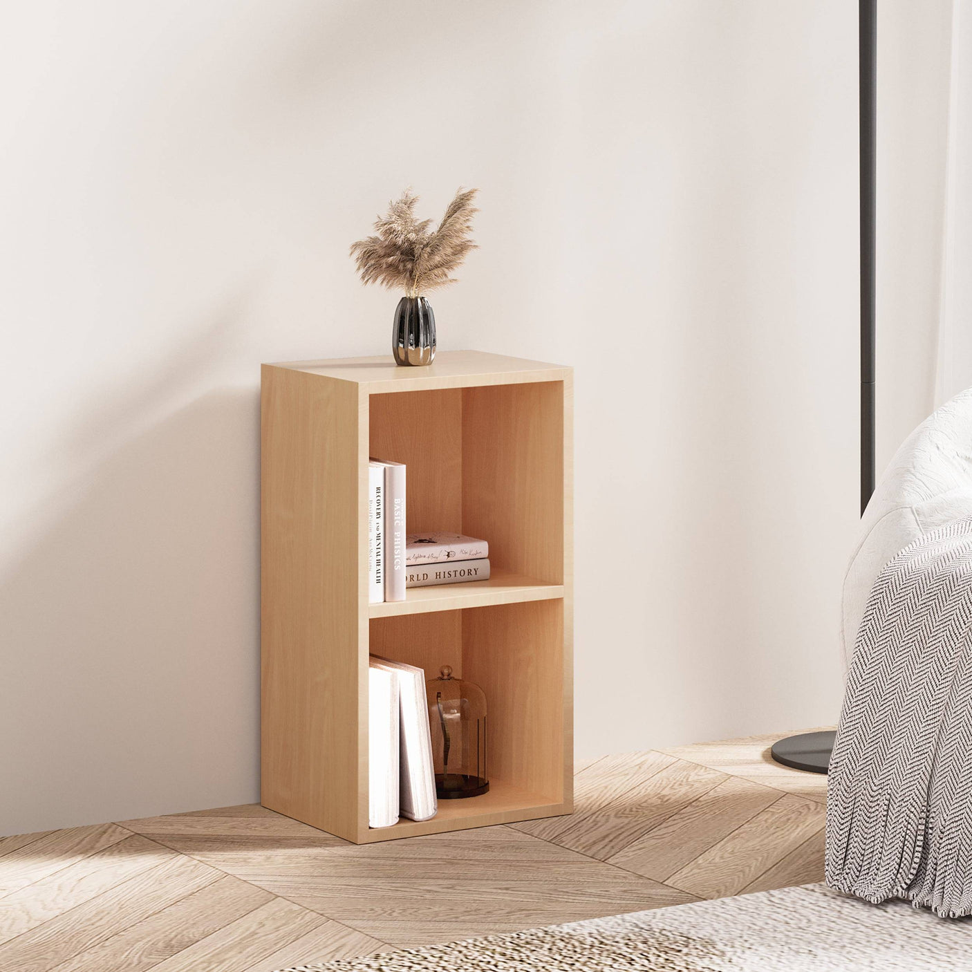 Natural wood Blisswood bookcase used as a nightstand with books and decor in a cozy bedroom.