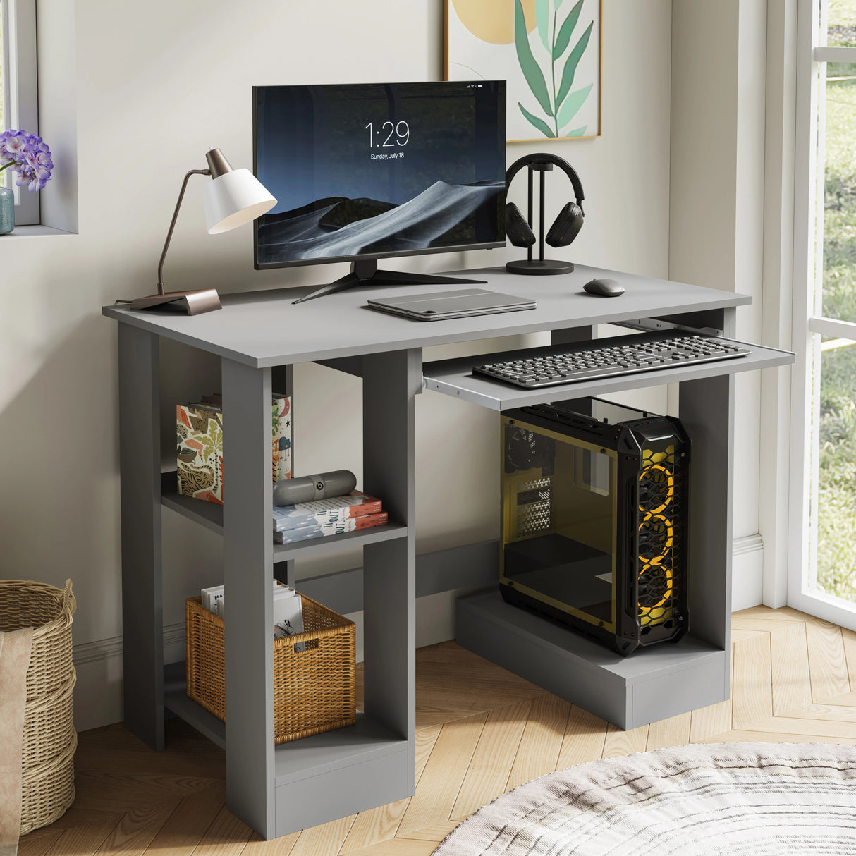 Home office computer desk with shelves in grey featuring a pull-out keyboard tray, monitor, and PC tower setup. Ideal for working, reading, and gaming.