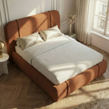 Slight overhead corner perspective of large king size orange bed frame with rounded headrest