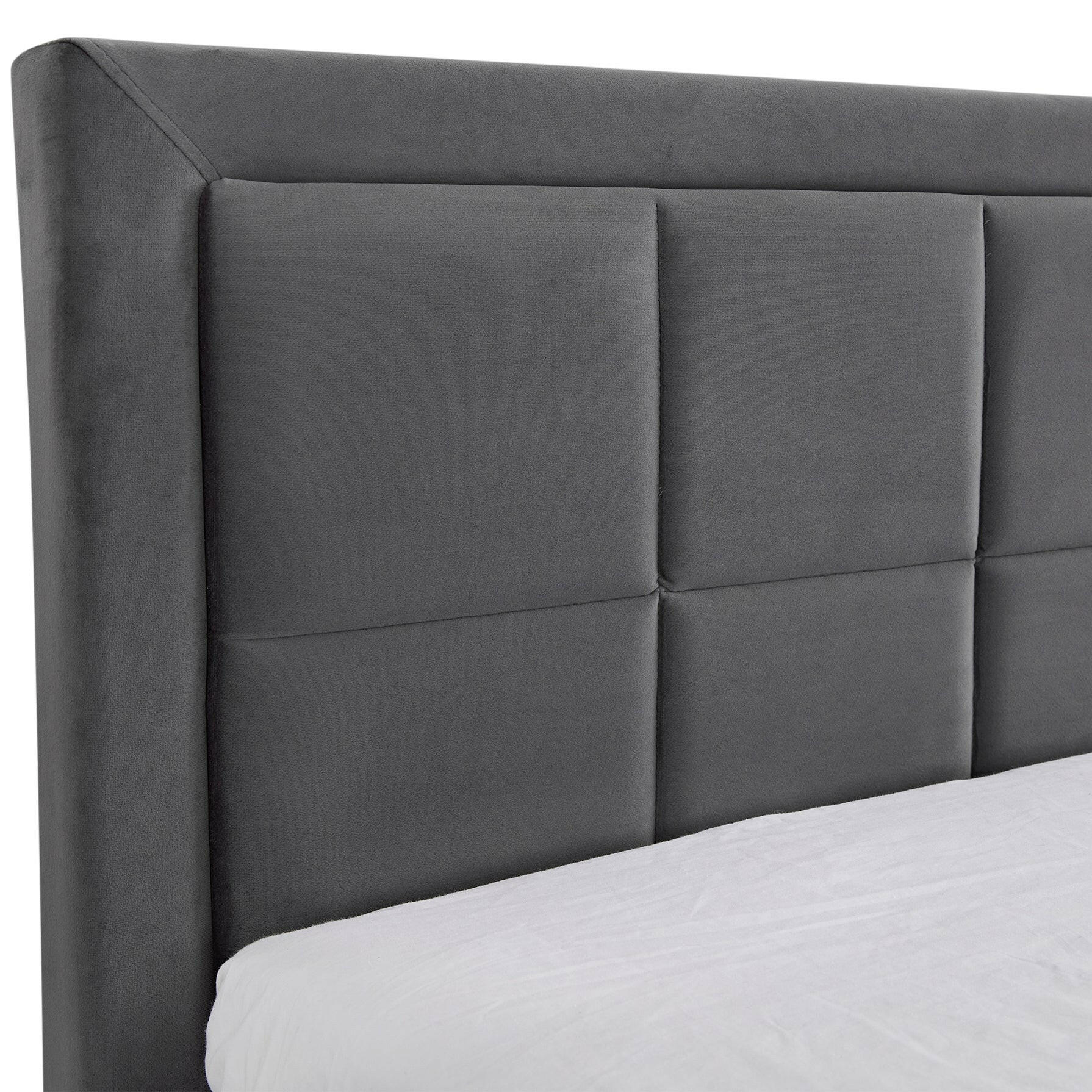 Close-up of a grey quilted headboard showcasing its sleek and modern design.