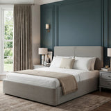Ottoman king size bed frame grey with ribbed headboard and footboard upholstrey placed in a bedroom