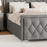 grey ottoman storage bed king size with a cross-puffed designed footboard placed near a bedside table in a bedroom