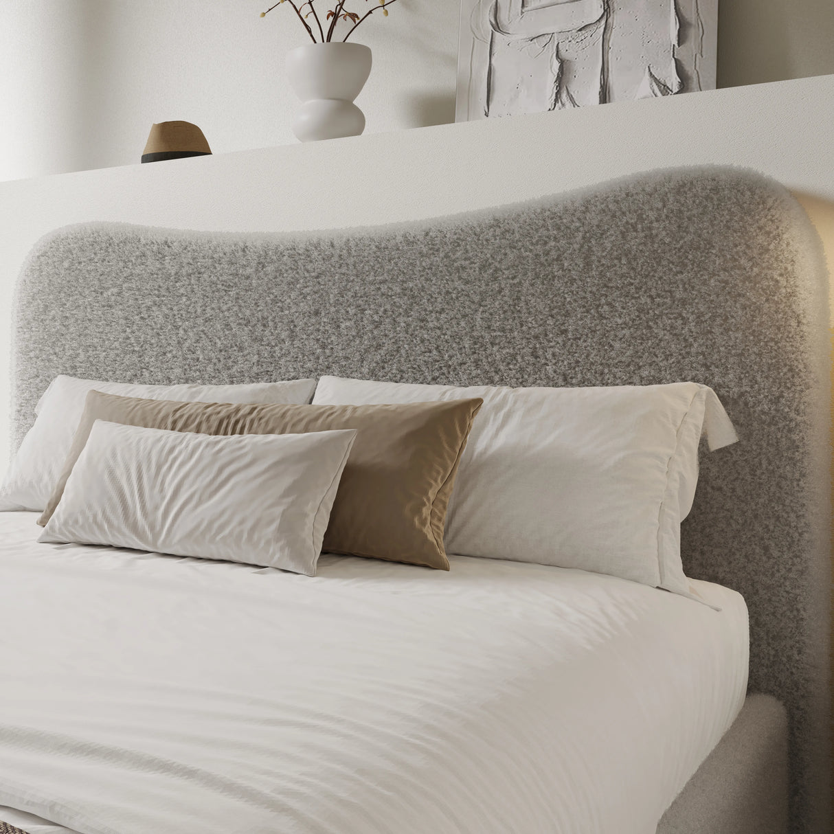 Curved headboard ottoman storage bed in boucle fabric with plush beige and white pillows. Stylish platform bed frame ideal for modern bedrooms.