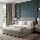 Ottoman storage double bed with ribbed headboard and footboard upholstrey placed in a bedroom