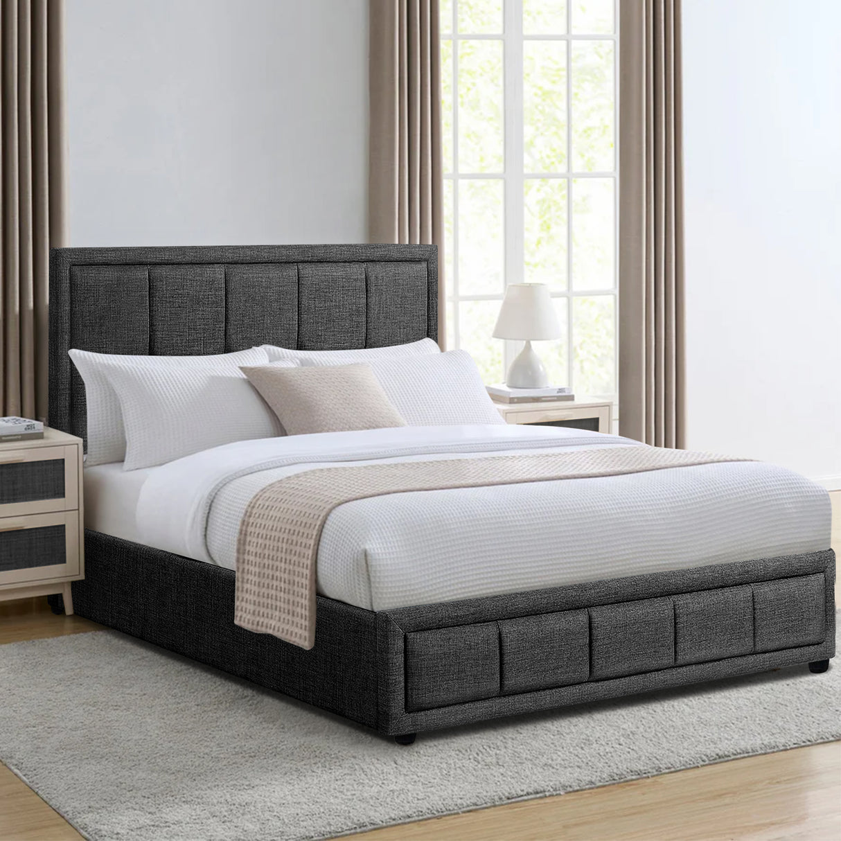 Dark grey ottoman bed frame with a tufted headboard, white bedding, and neutral décor.