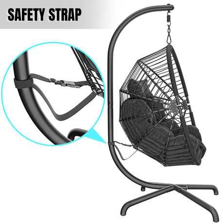 Outdoor hanging egg chair with safety strap, sturdy stand, and comfortable black cushions.