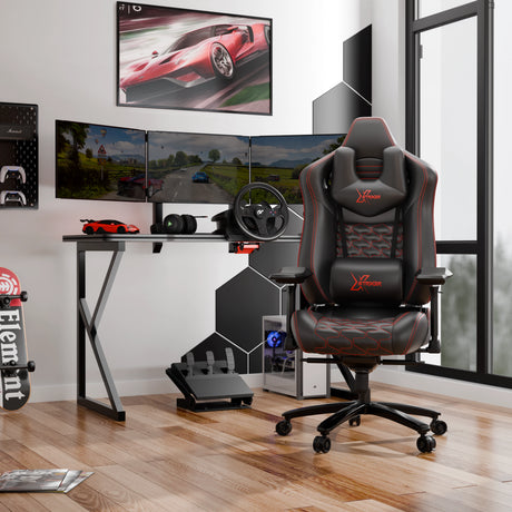 Gaming setup with a chair, desk, and multiple monitors in a room.