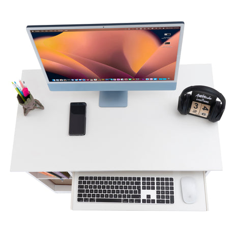 Top view of a sleek PC gaming desk setup with a monitor, keyboard, mouse.