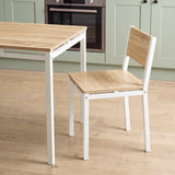 [Pine] Breakfast table edge & chair close-up with wood-effect panels, square grey metal frames, support rails & visible bolts
