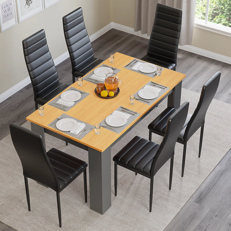 overhead view of grey pine wood garden table and 6 chairs with black leather upholstery and tableware