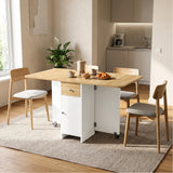 [Pine] Kitchen drop leaf table fully open and styled with four chairs, tableware, granola, croissants and two caster supports