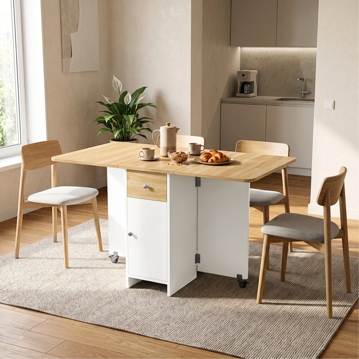 [Pine] Kitchen drop leaf table fully open and styled with four chairs, tableware, granola, croissants and two caster supports