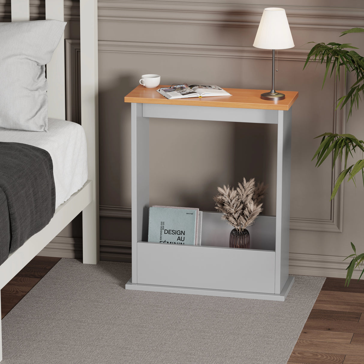 sofa end table in grey with oak top used as nightstand, books and lamp on top in minimal setting