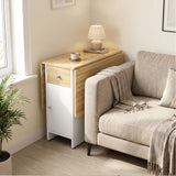 [Pine] Small folding dining table closed beside a sofa and window, featuring white cabinet and pine top with lamp and a mug.