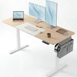 Pine Electric Standing Desk with dual monitors, laptop, and storage pocket, ideal for modern home office setups. Features adjustable height and cable management.