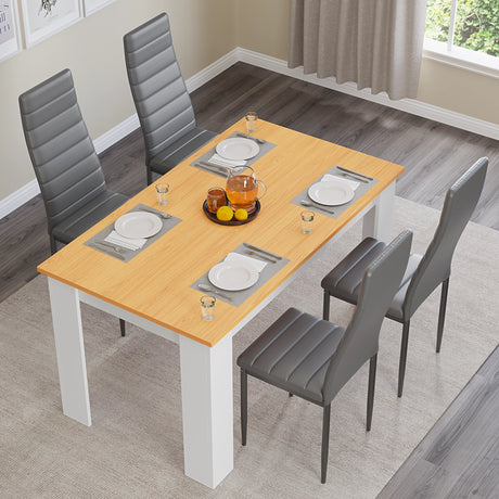 overhead view of kitchen table and chairs set with black leather seats and pine tabletop