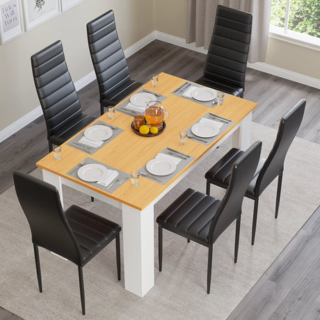 white pine dining room table and chairs with black leather upholstery arranged neatly for six diners