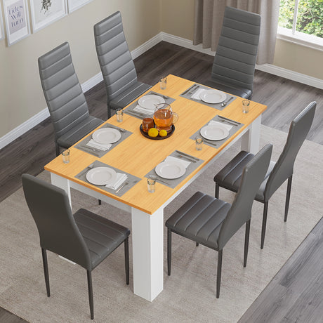 top-down view of white pine dining table and chairs set with grey leather seats arranged for six diners