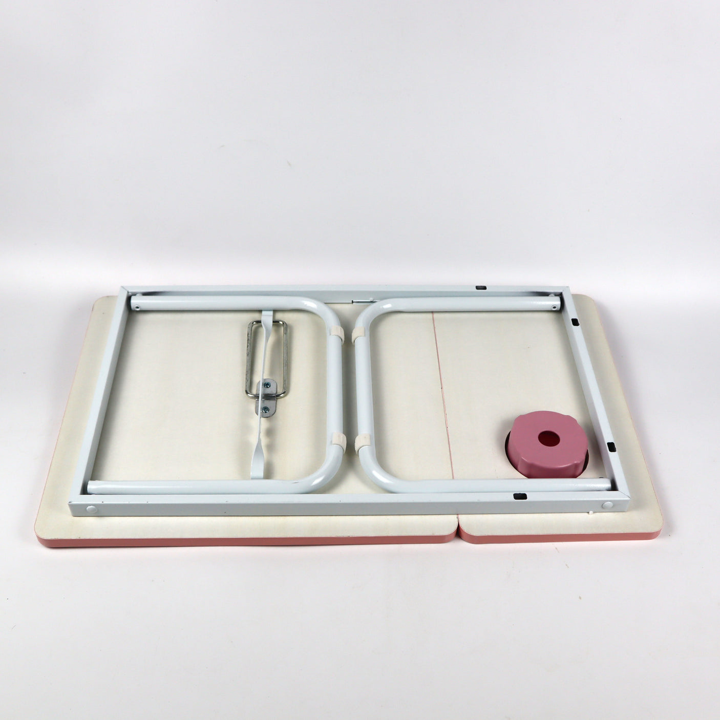 Pink foldable laptop desk with adjustable height, providing comfort and portability for use in bed, on the sofa, or any relaxed setting.