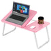 pink sofa laptop table fully opened with a raised surface holding a laptop and a cup in its holder