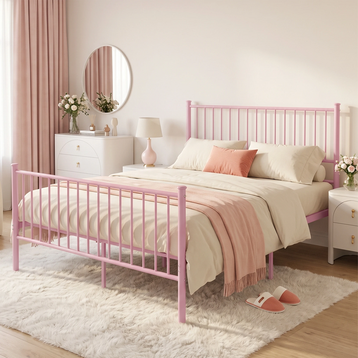 [Pink | King] Angled bedroom view showing a metal bed, cream bedding, coral cushion, round mirror, flowers, and fluffy rug.