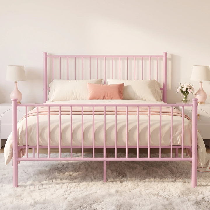 [Pink | King] Front view showing bar headboard and footboard, centre leg, cream bedding, coral cushion, and twin lamps.