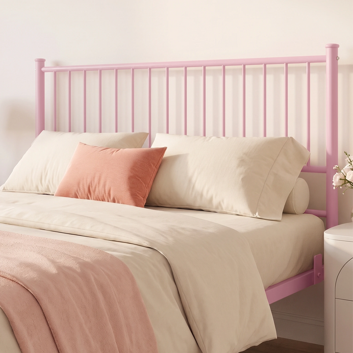 [Pink | King] Headboard close-up showing vertical bars, capped posts, cream pillows, coral cushion, and a flower vase.