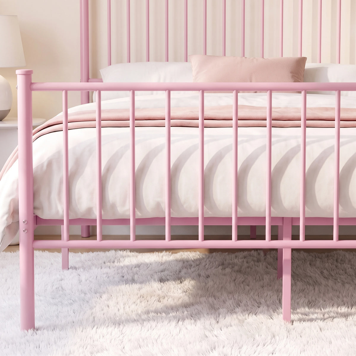 [Pink | Double] Close-up detail of the pink metal double bed frame's vertical slat footboard structure.