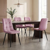 [Pink | Set of 4] Velvet dining chairs at a rectangular table, with curved tufted backs, armless seats and black metal legs.