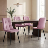 [Pink | Set of 4] Velvet dining chairs at a rectangular table, with curved tufted backs, armless seats and black metal legs.