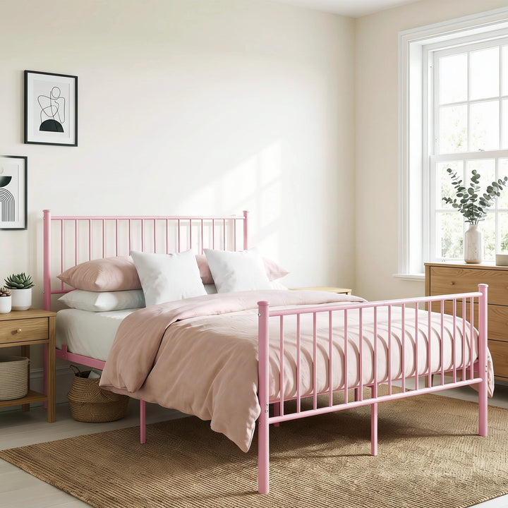 [Pink | King] Angled view of metal bed with pink-white bedding, bar headboard and footboard, centre legs, nightstand & plants