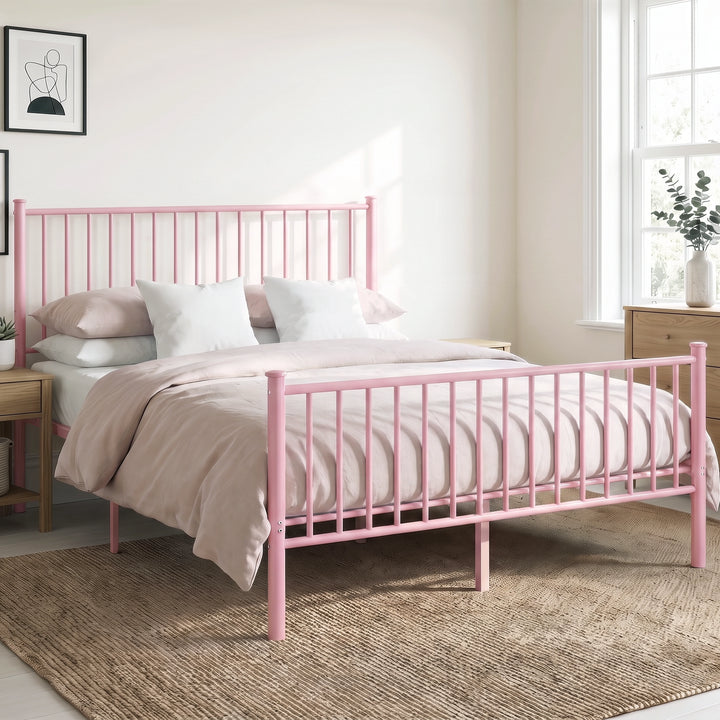 [Pink | King] Angled view of metal bed with pink-white bedding, bar headboard and footboard, centre legs, nightstand & plants