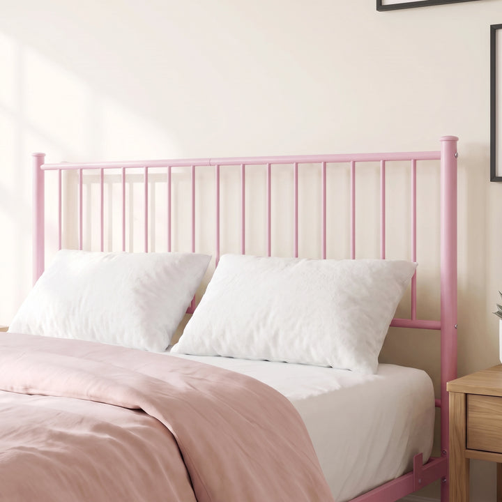 [Pink | King] Metal bed close-up of tall pink vertical-bar headboard with white pillows, pink bedding and abstract wall art.