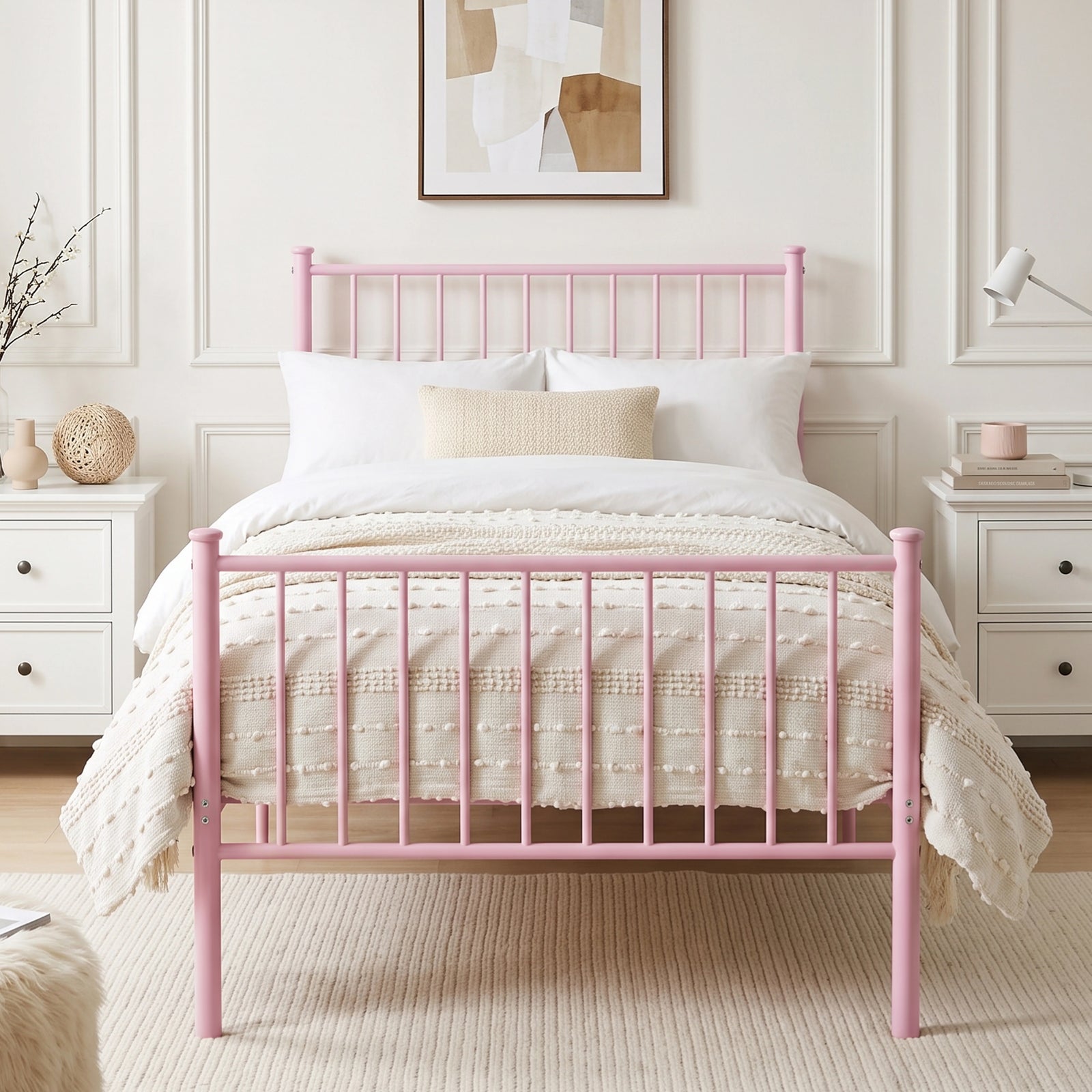 [Pink | Single] Front view of metal single bed with white bedding, beige throw, bar ends, centre leg, nightstands & wall art.