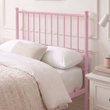 [Pink | Single] Metal bed close-up view of tall bar headboard with white pillows, beige knit cushion, lamp & bedside drawers.