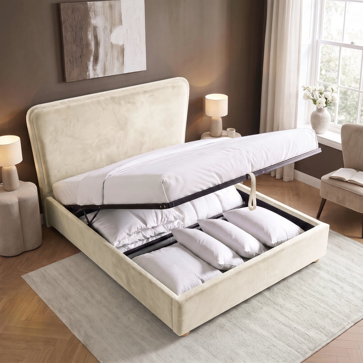 [King | Beige] Plush velvet Ottoman storage bed open showing gas-lift pistons, wooden slats, pull strap and storage bay