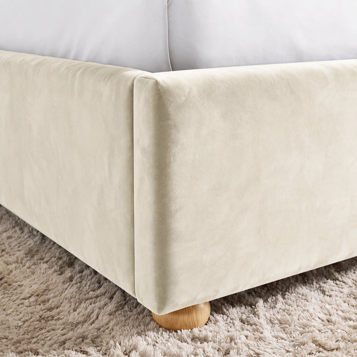 [Double | Beige] Close-up detail of the rounded wooden foot and upholstered corner of the Plush Velvet Ottoman Double