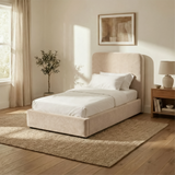 [Single | Beige] Wide lifestyle view of Pluva ottoman bed showing full room styling with nightstands and wall decor
