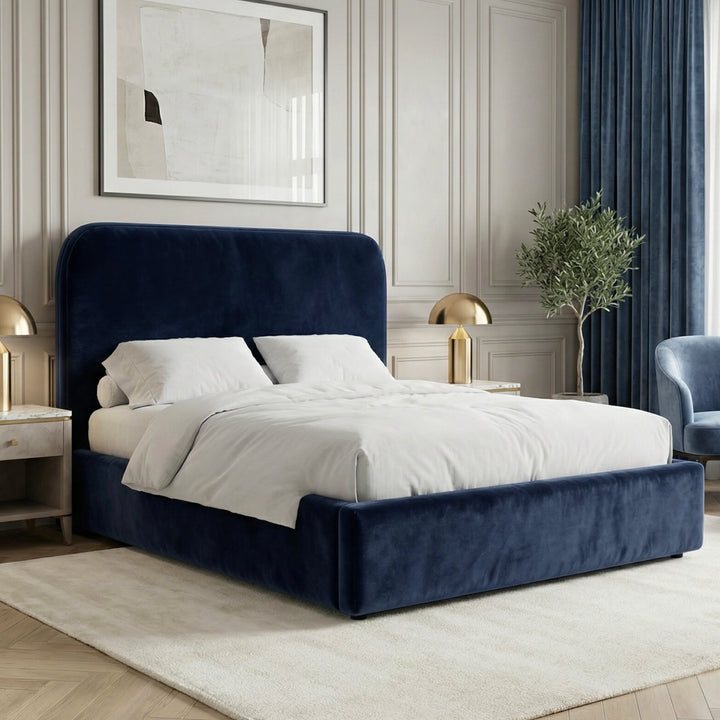 [Double | Blue] Pluva velvet ottoman bed with rounded headboard on cream rug below framed abstract artwork