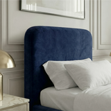 [Single | Blue] Pluva headboard detail showing smooth rounded shape with velvet upholstery beside nightstand