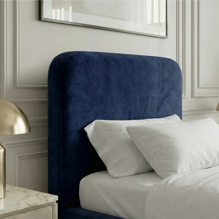 [Single | Blue] Pluva headboard detail showing smooth rounded shape with velvet upholstery beside nightstand