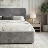 [King | Grey] Angled view of velvet ottoman bed showing headboard curve and upholstered side panel with bedding