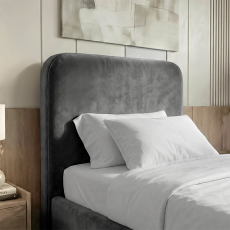 [Single | Grey] Detail view of rounded headboard with soft velvet finish and pillows arranged against padded surface