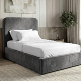 [Single | Grey] Three-quarter view of Pluva velvet bed with smooth rounded headboard and clean upholstered base