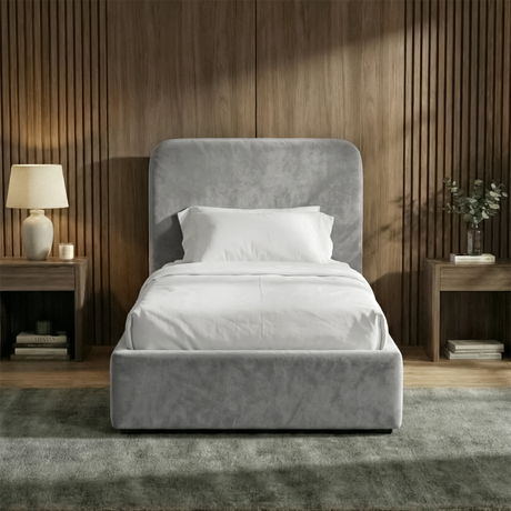 [Single | Light Grey] Front view of Pluva ottoman bed with curved headboard centred between matching nightstands and table lamps